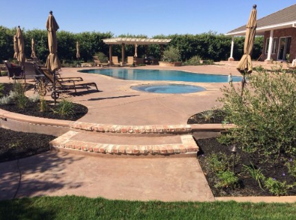 Picture of a stone and concrete pool deck, stairs, and patio done by Granite Bay's Masonry contractor
