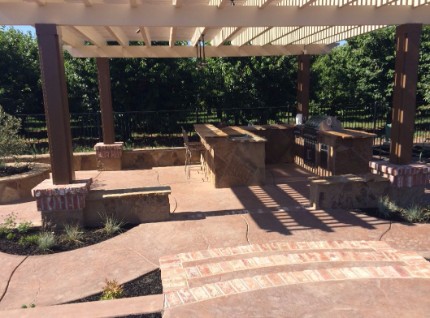 An image of a concrete patio and patio cover with a garden box and stamped concrete that has been cut in Granite Bay, Ca
